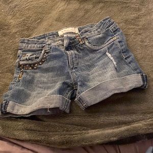 Denim cuffed jeans with silver studs.